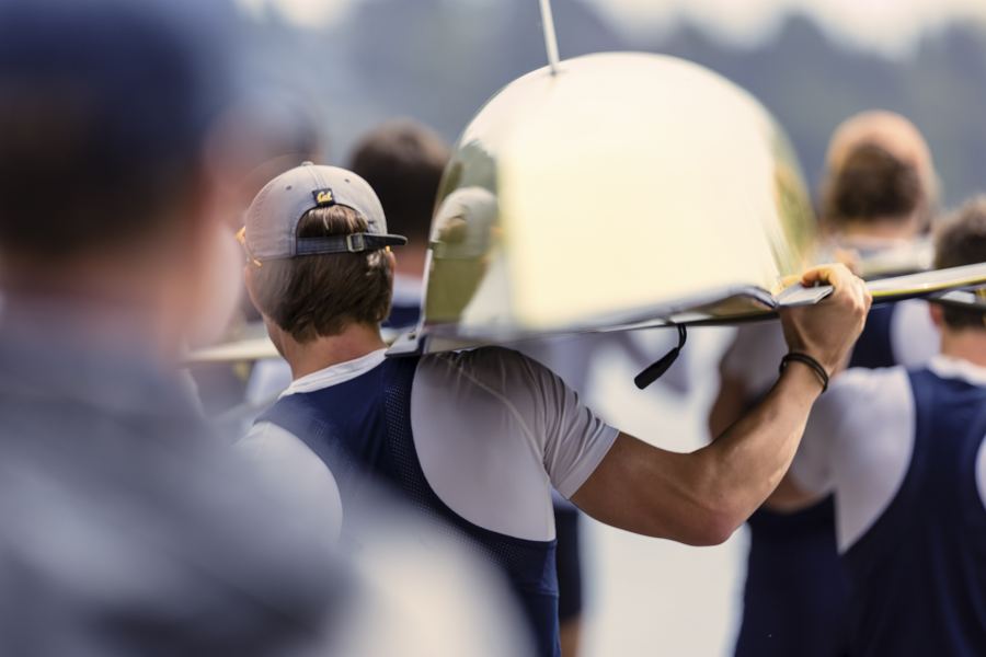 Rowers carrying their boat to the water before a race
